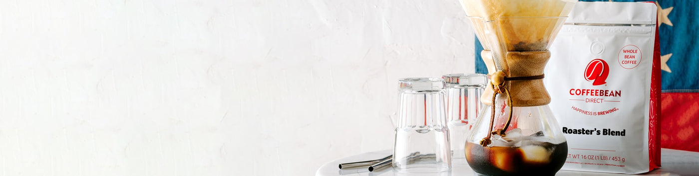 Subscription Landing Page hero image -- bag of coffee, pourover mug, and coffee glasses